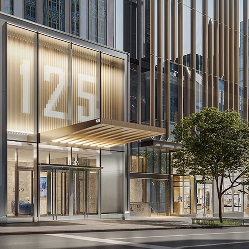A beautiful office building entrance with gold colored metal work